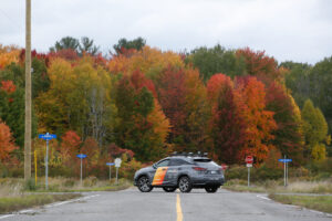 An Area X.O branded autonomous Lexus SUV parked on site in front of a forest of fall coloured trees - as part of the L5 test facility demos in Ottawa, Ontario, Canada on Oct. 6, 2020. Photo by David Kawai.