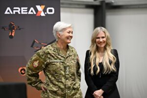 General Jennie Carignan, Chief of the Defence Staff;  and Sonya Shorey, President and CEO of Invest Ottawa and Area X.O standing together at the RED COBALT event at Area X.O Killaloe. 